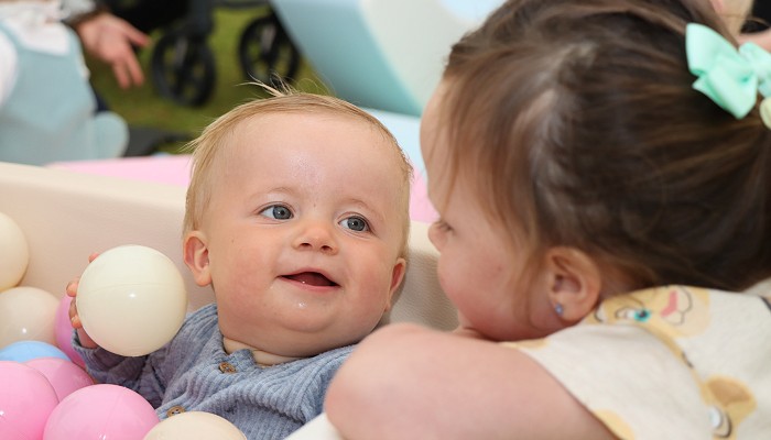 brother and sister smiling at eachother